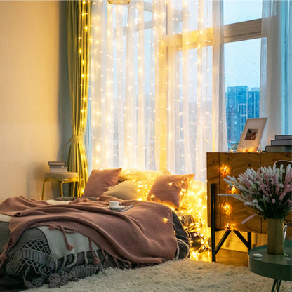 String lights on curtain in Cozy bedroom with fairy lights, pillows, and a city view.